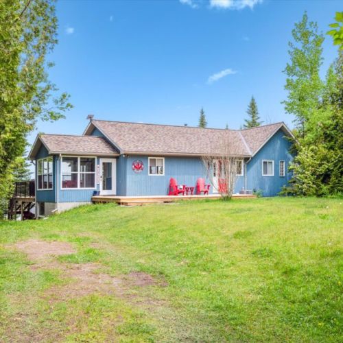 Arrive at your own private escape surrounded by lush greenery and a wide-open lawn, perfect for outdoor play or extra parking.
