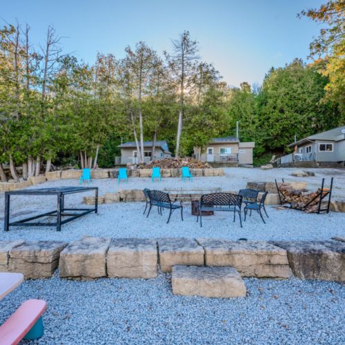 Cozy fire pit area with seating, perfect for evening gatherings to share stories and enjoy the warmth of a bonfire.