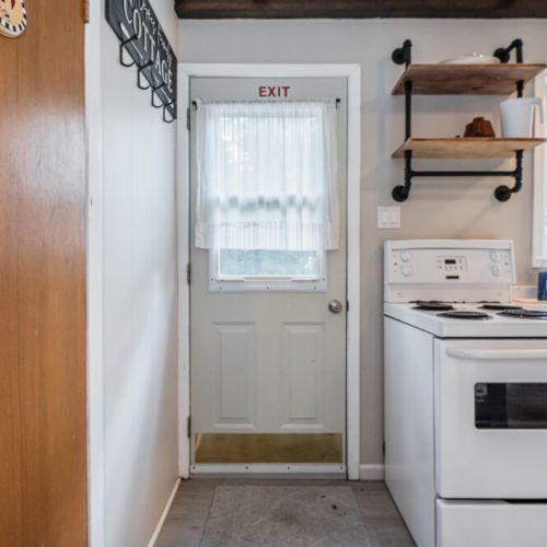 Access to the back yard just off of the kitchen, with hooks along the wall for your gear.