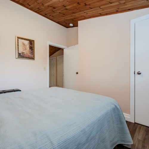 This cozy guest bedroom offers a welcoming atmosphere, ideal for a peaceful retreat after a day of adventure.