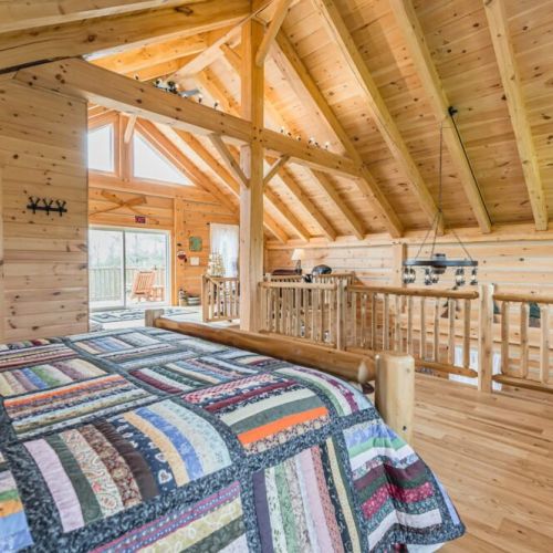 The loft bedroom offers a panoramic view of the surrounding woodland and waters. Step out onto the expansive balcony to enjoy the fresh air and breathtaking Huron sunsets.