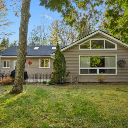 Whitecaps Cottage retreat nestled among the trees, just a short walk from the sandy shores of Lake Huron.