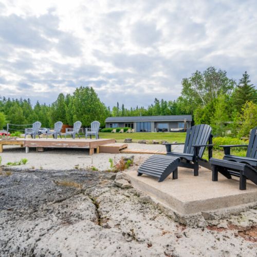 The waterfront lounge with Muskoka chairs.
