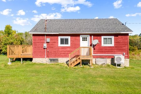 A charming country farmhouse surrounded by the quiet, natural landscape of the Bruce Peninsula.