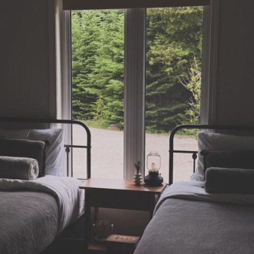Bedroom 2: Thoughtfully designed for restful nights, this cozy bedroom offers peaceful forest views and hotel-quality linens for a truly restorative stay.