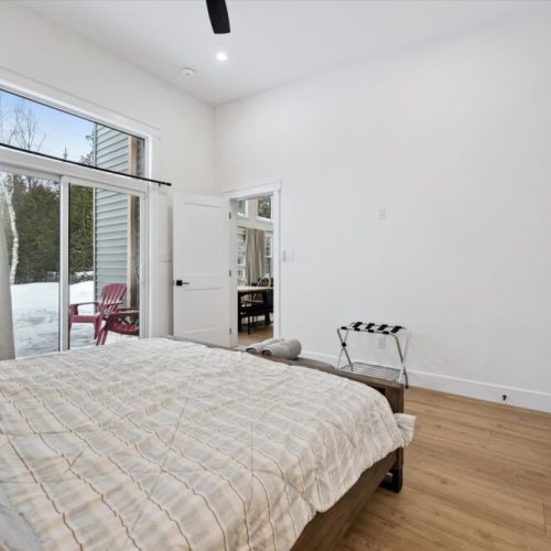 Main bedroom with sliding door access, offering a bright, airy feel and peaceful outdoor views.