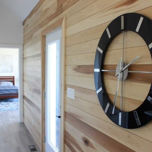 The Great Hall's clock on the birch wall is a stately and modern example of cottage timekeeping.