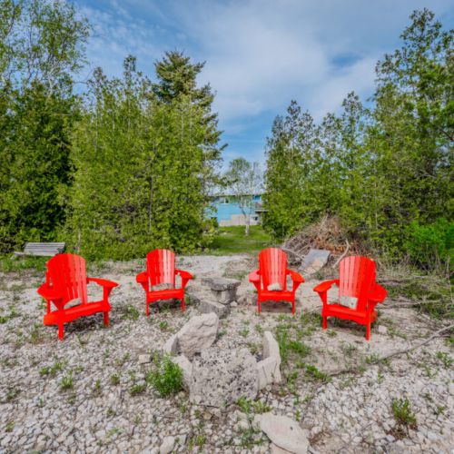 Full exterior view of Len Cove’s cottage and grounds, showcasing the space, privacy, and natural beauty surrounding your lakeside retreat.