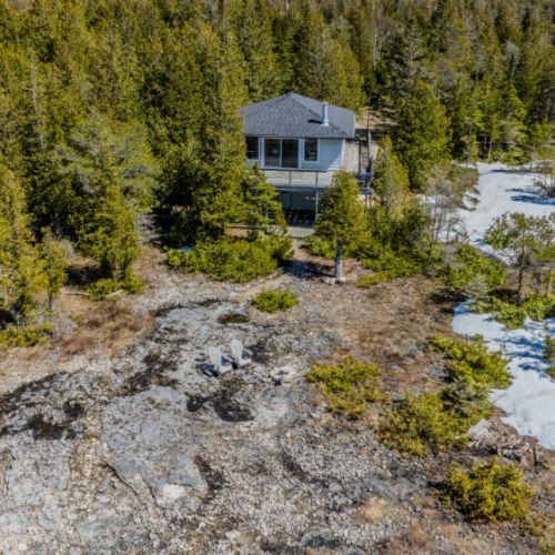 Rustic shoreline seating area just steps from your cozy cottage, ideal for sunset views, campfires, and lakeside relaxation.