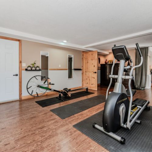 Home gym flows into a cozy fitness lounge and extra bedroom area, offering comfort and convenience for active travelers.