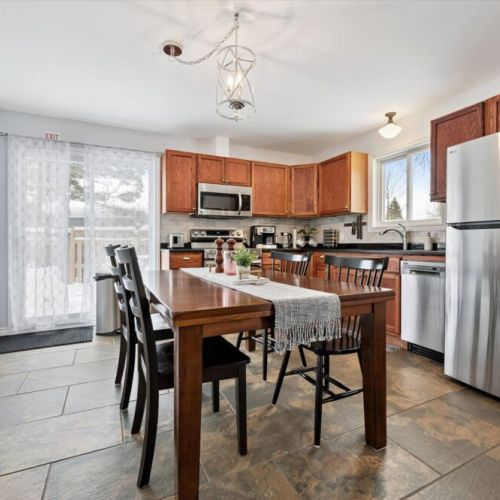 Updated kitchen and dining space with stainless-steel appliances, new cabinetry, and room for shared meals.