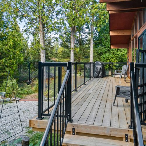 Stretch out on the expansive wraparound deck and soak in the sights and sounds of the surrounding forest.