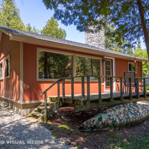 Front deck view of Breezy Woods Cottage—quiet, shaded, and perfect for morning coffee or evening unwinding.