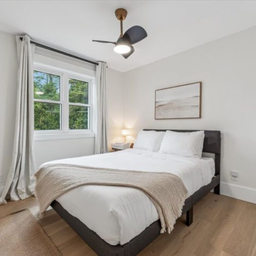Wake up to natural beauty in this serene cottage bedroom, thoughtfully designed for your comfort and relaxation.