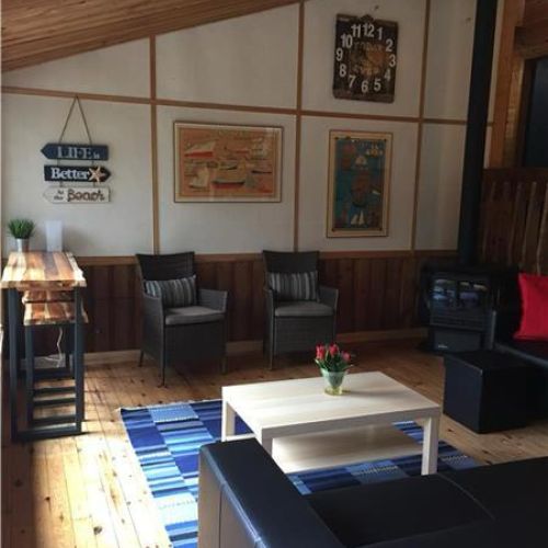 Bright and comfortable living space with cozy seating—perfect for relaxing after a day by the lake.