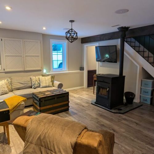 Cozy lounge area featuring a wood stove and TV — perfect for relaxing evenings after exploring.