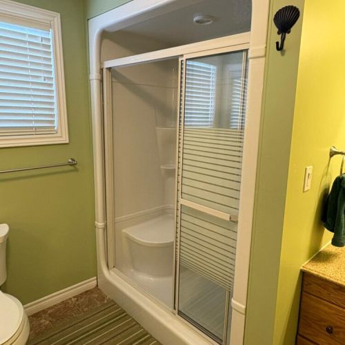 Easy-access shower with sliding doors for a comfortable, refreshing rinse.