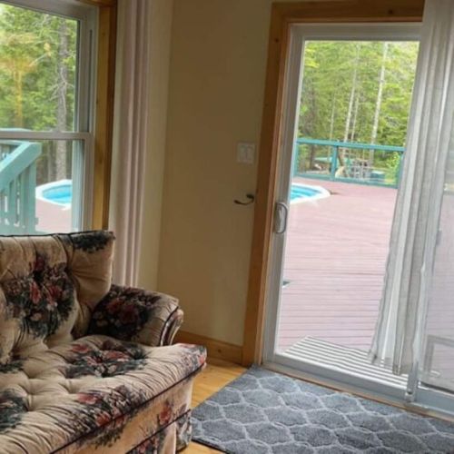 Charming sunroom corner with pool views and vintage decor—perfect for reading, relaxing, or planning your day’s adventures.