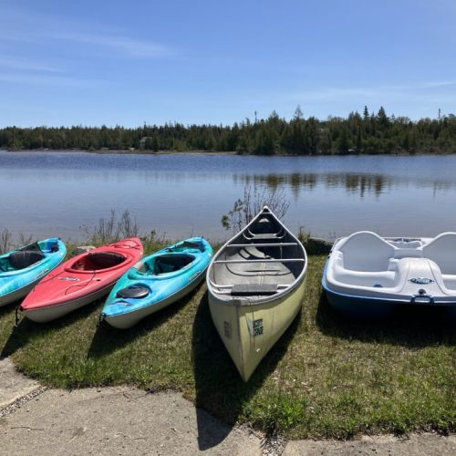 Kayaks, canoe, and paddle boat ready to explore