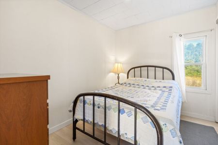The second main-floor bedroom offers a cozy and private space to relax and recharge.