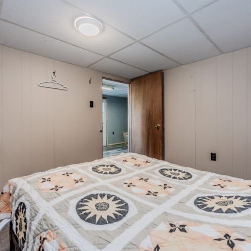 This angle showcases the bedroom’s open design, with hooks on the wall for convenience.