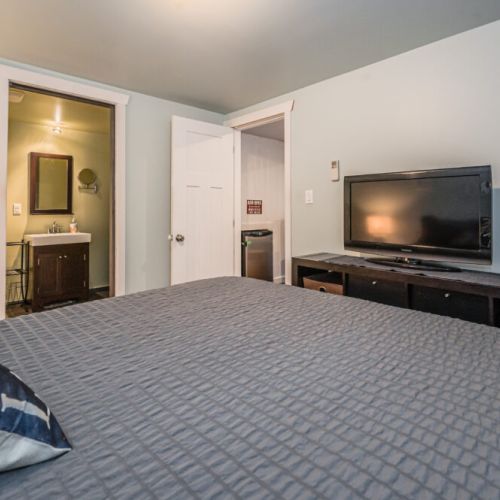 Bedroom 3: Private bedroom with TV and convenient access to nearby amenities.