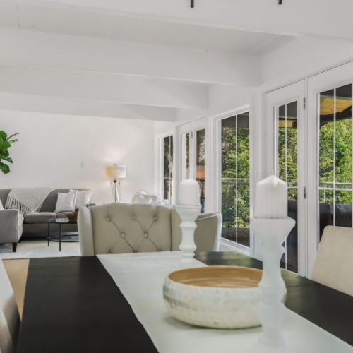 Dining table with a bright airy feel and patio doors that bring the outdoors in.