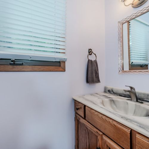 Freshen up in a charming, private bathroom with stylish fixtures and natural light—an inviting touch for your holiday stay.