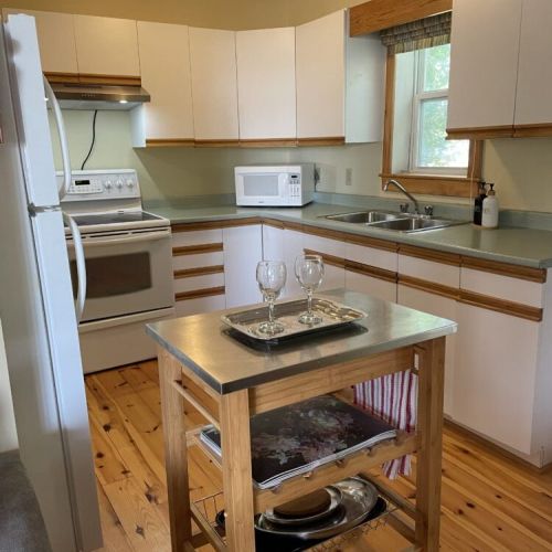 A charming kitchen space with island for prepping and sharing meals