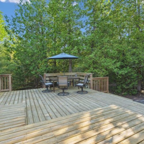 Outdoor dining at its best: shaded table for four surrounded by the quiet of 35+ acres of private forest.