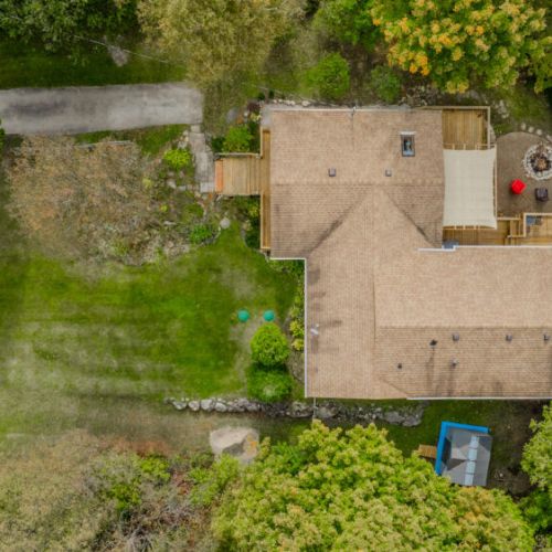 A bird's-eye view of the home, showcasing the spacious deck and backyard, ideal for outdoor gatherings and relaxation.