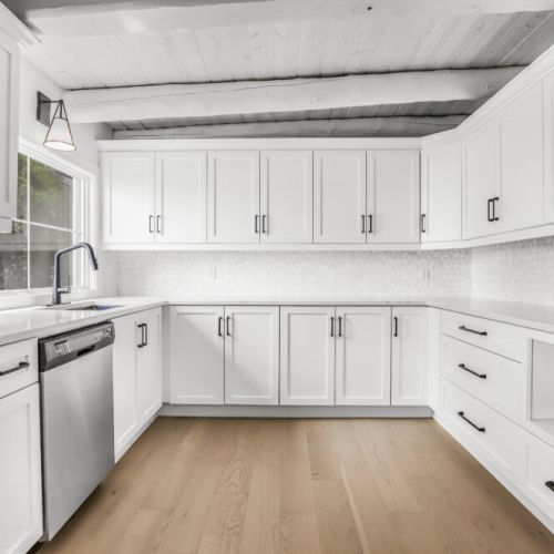 Clean white cottage kitchen with a roomy layout that makes meal prep easy.