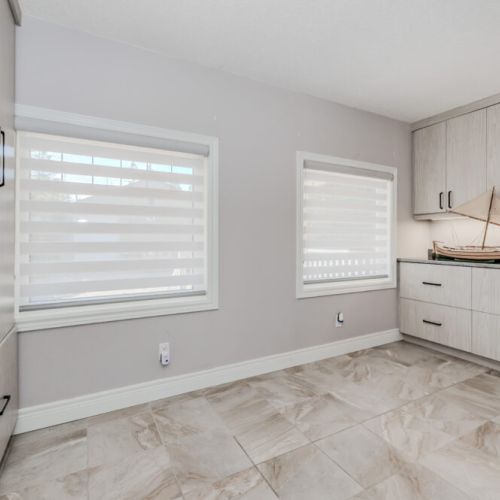 Modern laundry room with ample counter space and cabinetry—perfect for extended vacation stays, family getaways, or lakeside adventures that call for fresh clothes anytime.
