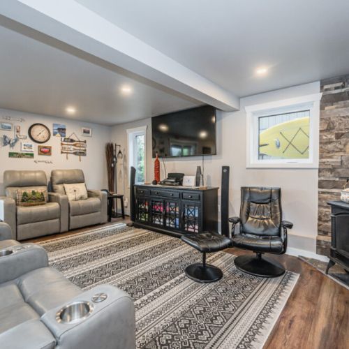 Cozy lower-level lounge with large TV—perfect for movie nights after a day on the water.