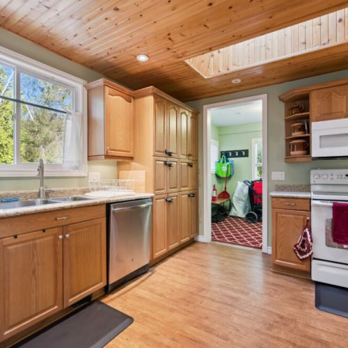 Large sink and prep area with a sunny window view to keep things bright and inviting.