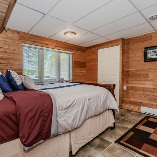 The lower Guest bedroom envelops you in warm finishes for a restful night's sleep after a day of lakeside adventures.
