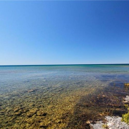 Crystal-clear, shallow shoreline—perfect for swimming, wading, and enjoying Lake Huron’s calm waters.