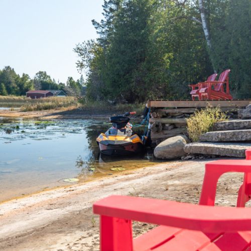 Easy waterfront access with space to launch a kayak or jet ski and relax by the shore.