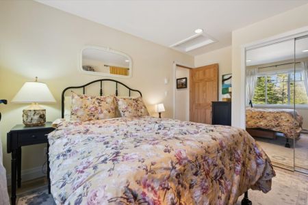 Another inviting bedroom offers a peaceful space to unwind, with soft natural light and comfortable furnishings.