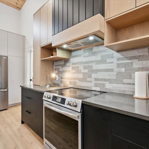 Stylish kitchen detail showcasing high-end finishes, modern backsplash, and full-size stove.