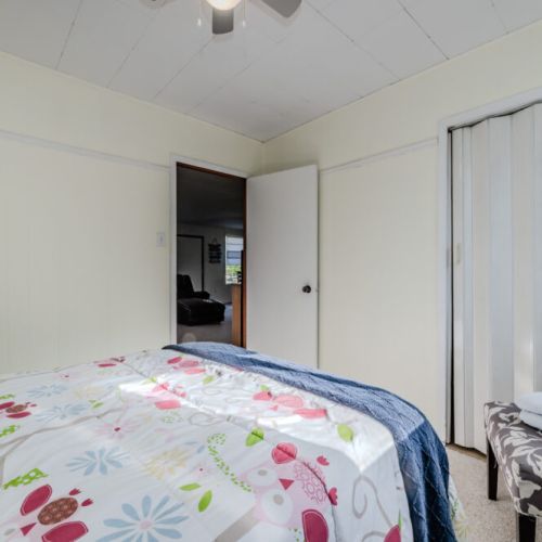 Light-filled room with charming décor and cozy chair, great for reading or relaxing—ideal for solo travelers or couples on a peaceful getaway.