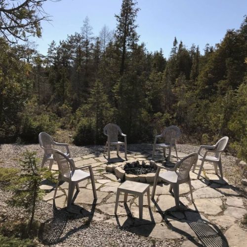 Create memories with family and friends at the private fire pit area, a must-have for your relaxing cottage getaway.