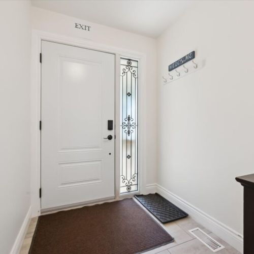 The welcoming front entrance provides easy access and convenient space for coats, shoes, and outdoor gear.