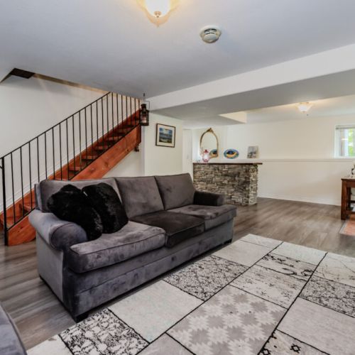 The open-plan living area includes a stylish stone bar and a workspace, making it an ideal spot for both leisure and productivity if needed.