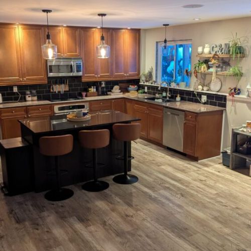 Modern kitchen with stainless appliances, ample counter space, and everything needed for preparing meals.