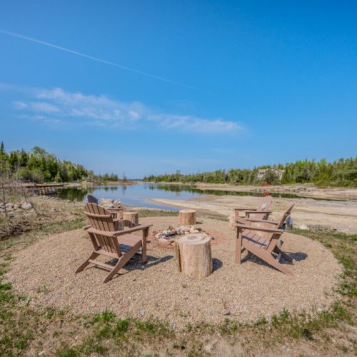 Gather around the fire pit by the water, a perfect spot for evening bonfires and stargazing, creating memorable experiences with family and friends.