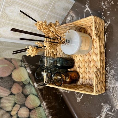 Elegant and rustic home decor featuring a scented diffuser and decorative glasses, adding a touch of coziness and class to the cottage.