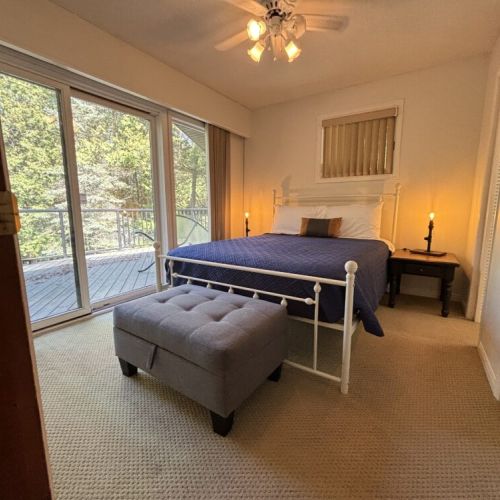 The Master bedroom opens to the back deck, inviting the gentle morning breeze inside.