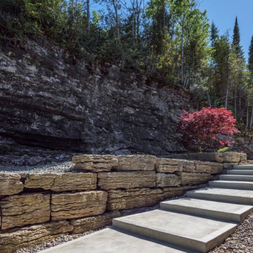 Natural stone landscaping blends seamlessly into the rugged beauty of the Bruce Peninsula.