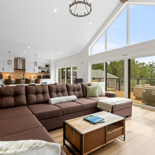 Unwind in the spacious living room with comfortable seating and easy access to the deck.